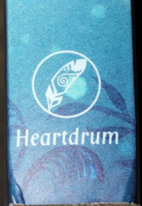 logo with a feather inside a circle and the word Heartdrum